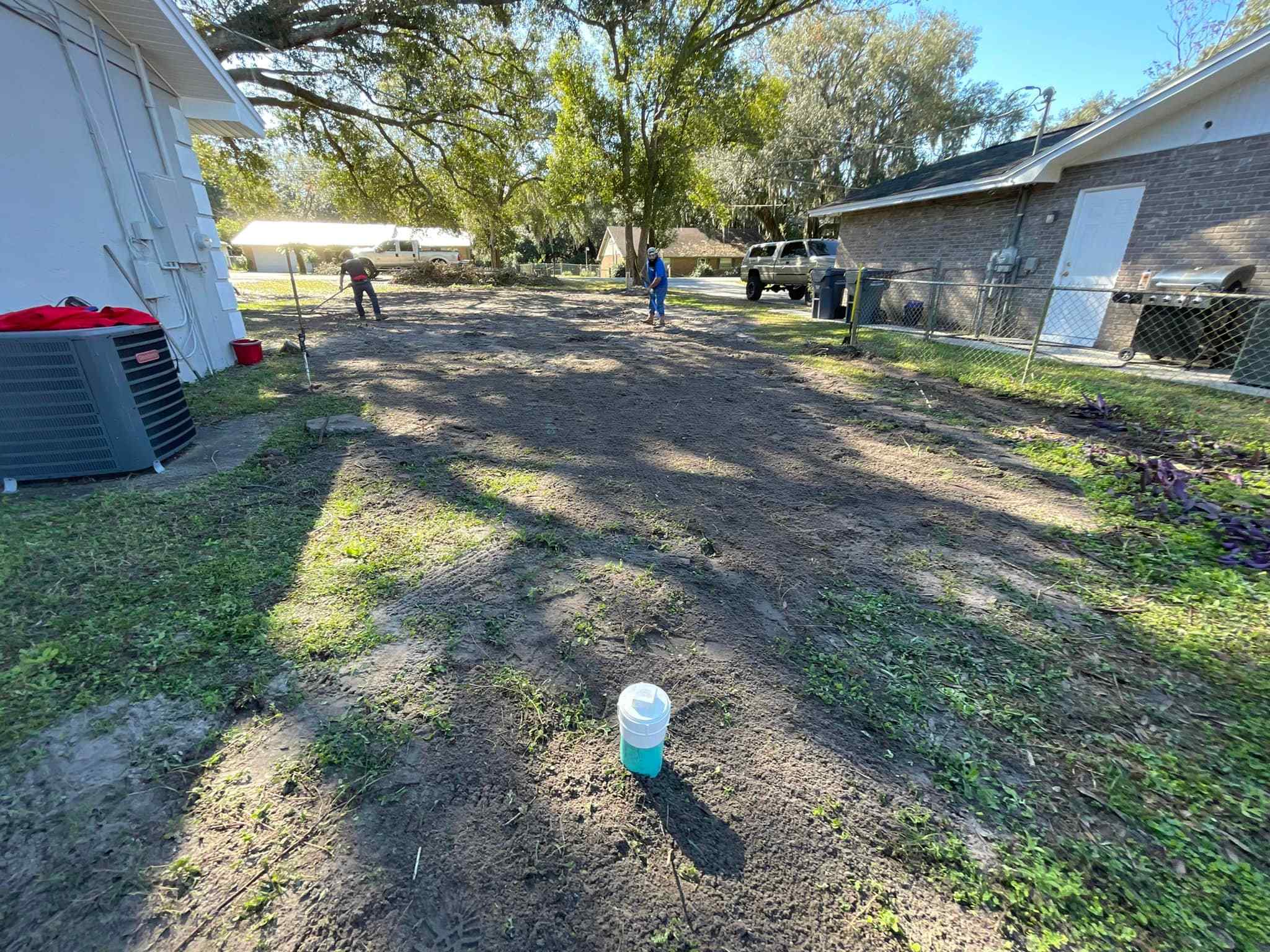 A yard with a lawn mower and Victor Plumbing signage in the middle of it.